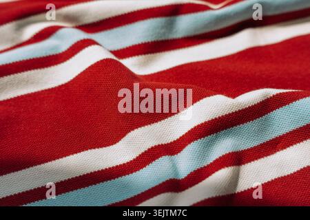 Red striped fabric with soft folds and texture Stock Photo