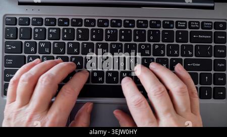 Hands of a person actively typing on a laptop keyboard, engaging in various digital tasks, demonstrating productivity, communication, and technology Stock Photo
