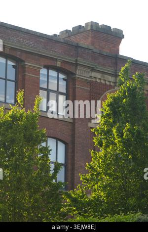 Sunny Red Brick Victorian Building Facade with Large Windows Stock Photo