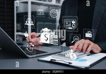 Financial management and business accounting analytics concept. Businessman using calculator and laptop to analyze budget planning, fund investment Stock Photo