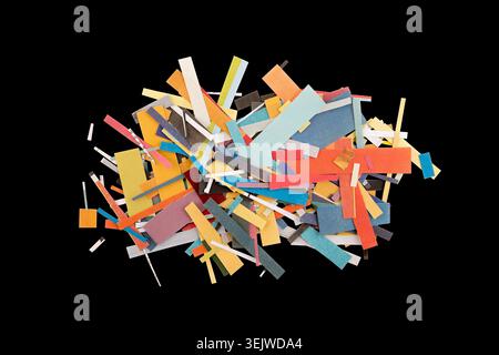 Scraps of colorful paper from magazines and newspapers isolated on black background Stock Photo