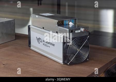 Amsterdam, Netherlands, May 23, 2026. A professional Whatsminer M30S++ ASIC cryptocurrency mining hardware unit resting on a wooden surface inside a s Stock Photo
