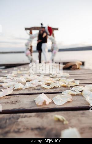 Soft petals drift across weathered wooden planks Stock Photo