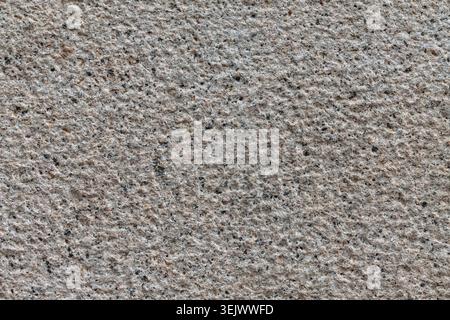 Uniformly chiseled granite stone background texture material macro Stock Photo