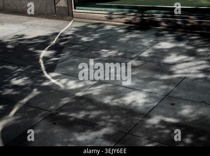 Sunbeams shining on an urban sidewalk Stock Photo