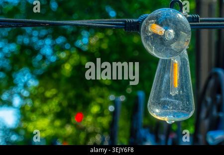 A string of festive light bulbs on a pation Stock Photo