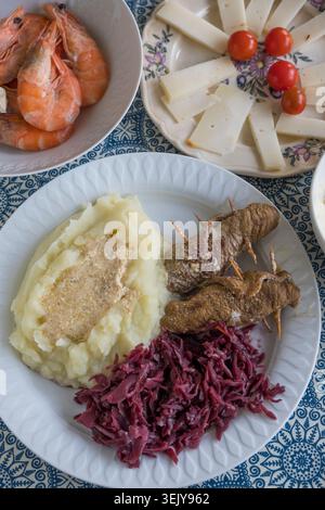 German beef roulades with red cabbage and mashed potatoes, prawns and cheese Stock Photo