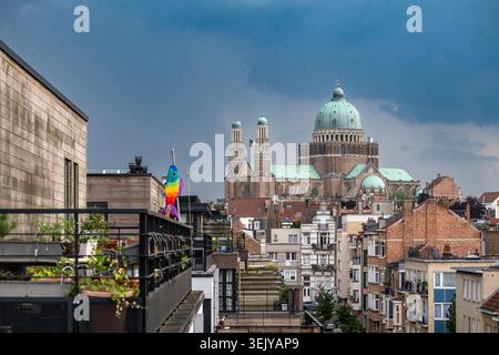 A wide elevated view shows a storm with dark blue clouds over street, terraces, houses and apartment buildings in Jette, Brussels. The National Basili Stock Photo