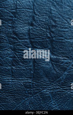 Close up, macro of detailed texture of blue glossy metallic effect leather surface with wrinkles, creases and natural grain. Textured luxury material Stock Photo