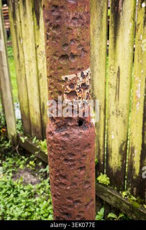 Severely corroded metal post with rust damage in tropical climate Stock Photo