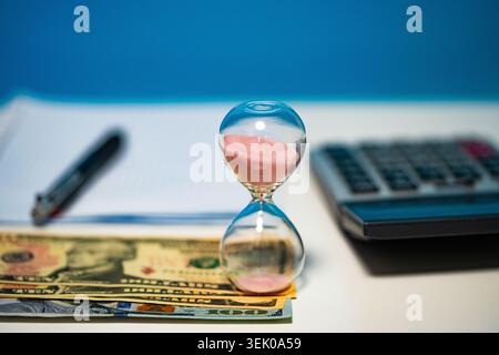 Late Invoice And Billing Deadline With Hourglass At Desk Stock Photo