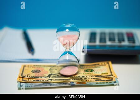 Late Invoice And Billing Deadline With Hourglass At Desk Stock Photo