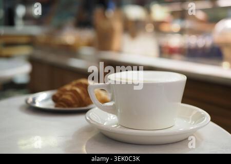 Coffee and croissant served at a cafe in the morning Stock Photo