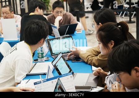 Engineers from Tencent Cloud Developer Community installed the open-source AI intelligent agent OpenClaw for free for citizens in Jiangcun Street, Hangzhou, Zhejiang Province, China on May 30, 2026. Stock Photo