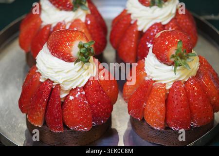 Delicious strawberry cupcakes with cream on a silver tray Stock Photo