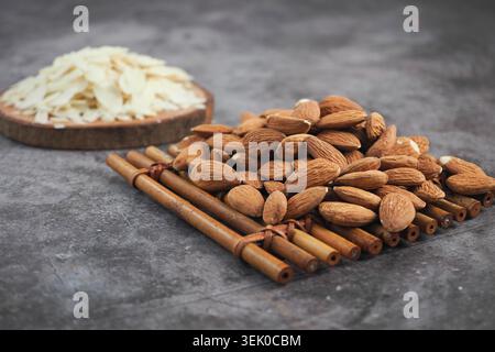 Almonds and sliced almonds on natural wooden surface Stock Photo