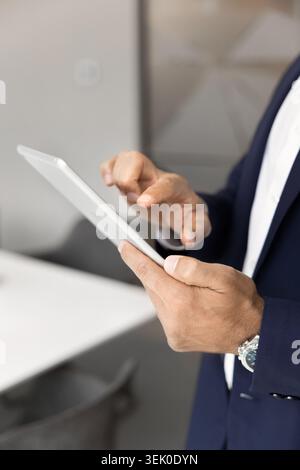 Businessman using digital tablet in office, close-up Stock Photo