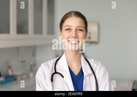 Headshot portrait of smiling female doctor or nurse Stock Photo