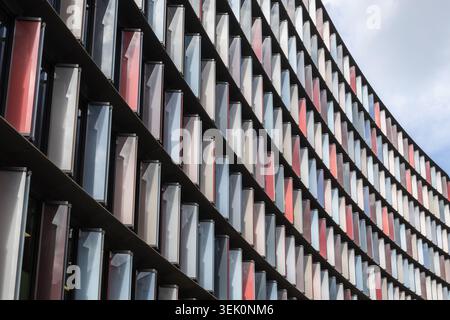 Modern curved office building facade with geometric window pattern Stock Photo