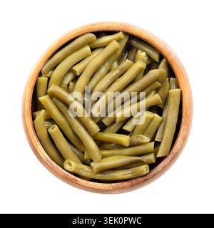 Canned cut green beans in a wooden bowl. Young green bean pods, sliced crosswise into uniform pieces and pressure-cooked. Stock Photo