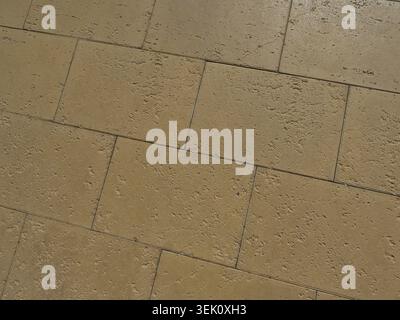 Stone pavement sidewalk in Palma with textured surface and warm tones. Top view in direct sunlight. Copyspace. Stock Photo