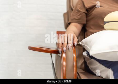 Client waiting comfortably at a nail salon chair before gel manicure treatment highlighting beauty care relaxation grooming and self care services Stock Photo