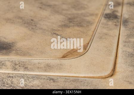 A detailed macro view showcases the rustic charm of aged leather, highlighting its unique texture and precise stitching Stock Photo