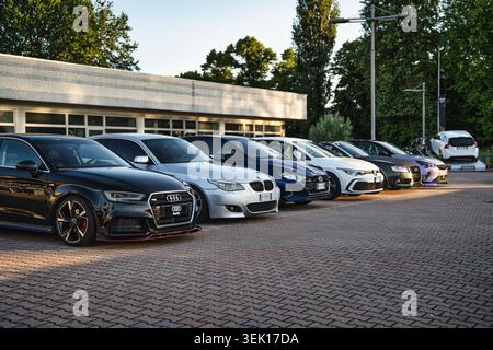 Rome, italy 29 may 2026: line of diverse automobiles parked outside a dealership, showcasing modern transportation and lifestyle. Sunlight highlightin Stock Photo