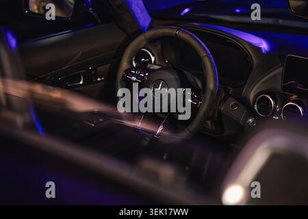 Rome, italy 29 may 2026: mercedes-benz luxury car interior with leather steering wheel, dashboard and ambient blue night lighting, modern high-end det Stock Photo