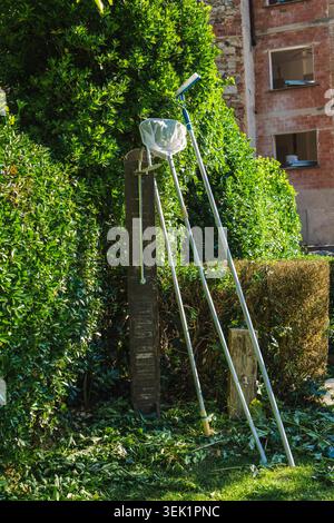 Pool maintenance equipment and cleaning tools beside swimming pool in Mediterranean countryside garden Stock Photo