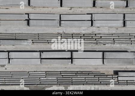 Concrete slabs and building materials forming a repetitive geometric pattern from above Stock Photo