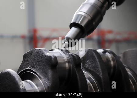 Engineers are working on the crankshaft. Stock Photo