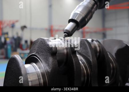 Engineers are working on the crankshaft. Stock Photo