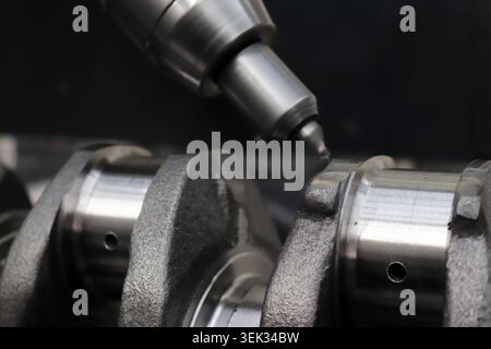 Engineers are working on the crankshaft. Stock Photo