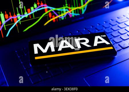 Marathon Digital Holdings Logo Displayed On Mobile Phone With Stock Market Performance Chart Background And Trading Graph Interface Stock Photo