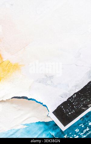 Distressed Urban Paper Collage with Torn Advertising Remnants on Wall Texture Stock Photo