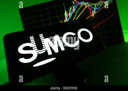 SUMCO Logo Displayed On Mobile Phone With Stock Market Performance Chart Background And Trading Graph Interface Stock Photo
