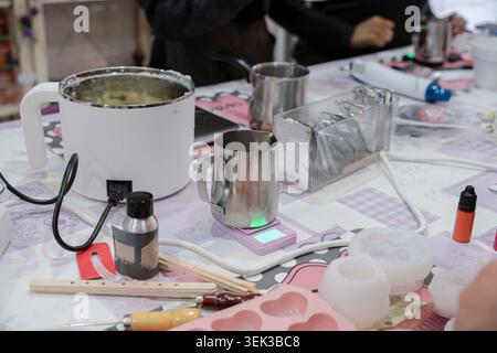 Crafting area with tools and materials for DIY candle production Stock Photo