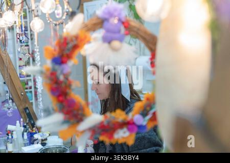 Woman focusing on crafting decorative objects, making handmade products in a vibrant workshop Stock Photo