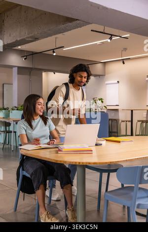 Cable connector set lying on wooden tabletop showing two black connectors with colored wires Stock Photo