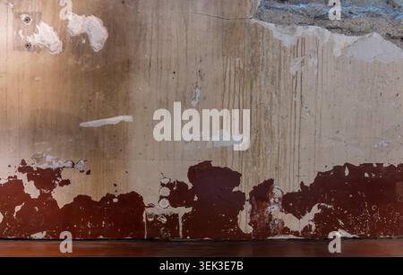 Wall Background. Detail view of an old brown and yellow wall with drips and layers of paint Stock Photo