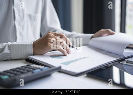Professional review of business data and use of the calculator Stock Photo