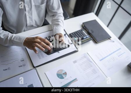 Male professional working on a digital tablet in office Stock Photo