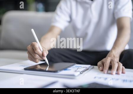 Businessman working on digital tablet graphic designer drawing on graphics tablet creative learning, working at home Stock Photo