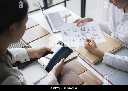 Interior designers discussing creative ideas for furniture design in a joint meeting? Stock Photo