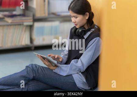 Young Asian student studying on tablet at university Stock Photo