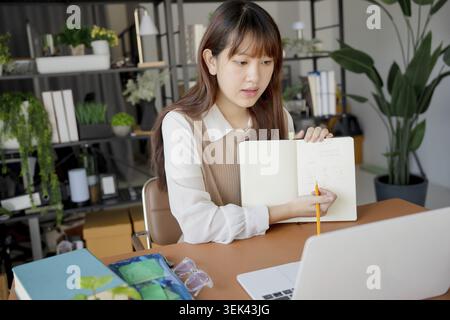 Asian woman studying with laptop student studying online at college Stock Photo