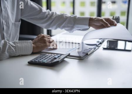 Professional review of business data and use of the calculator Stock Photo