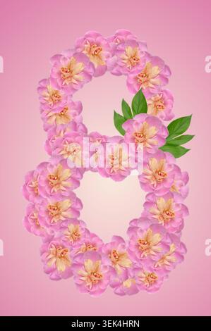 The number eight is made from pink peony buds with green leaves on a delicate pink background. Stock Photo