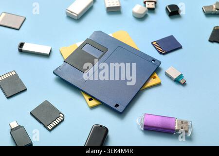Composition with floppy disks, USB flash drives and SD cards on blue background Stock Photo